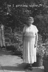 Card with black and white photo of a smiling woman and the words “am I getting older…”