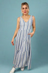 Model is wearing a maxi style linen blend striped dress with tank straps and a v-neck.