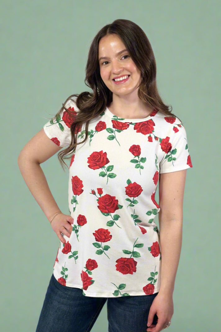 Model is wearing a bright white red rose printed tee shirt.