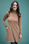 A mock neck, long sleeve dress in the color mocha. It as side pockets and hand stitch details.