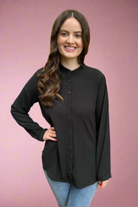 A women’s button down blouse in black featuring long sleeves, a mandarin collar, and subtle shimmer stripes.