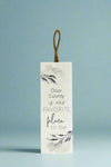 A vertical sign with rope hanging that says “Door County is our favorite place to be.”