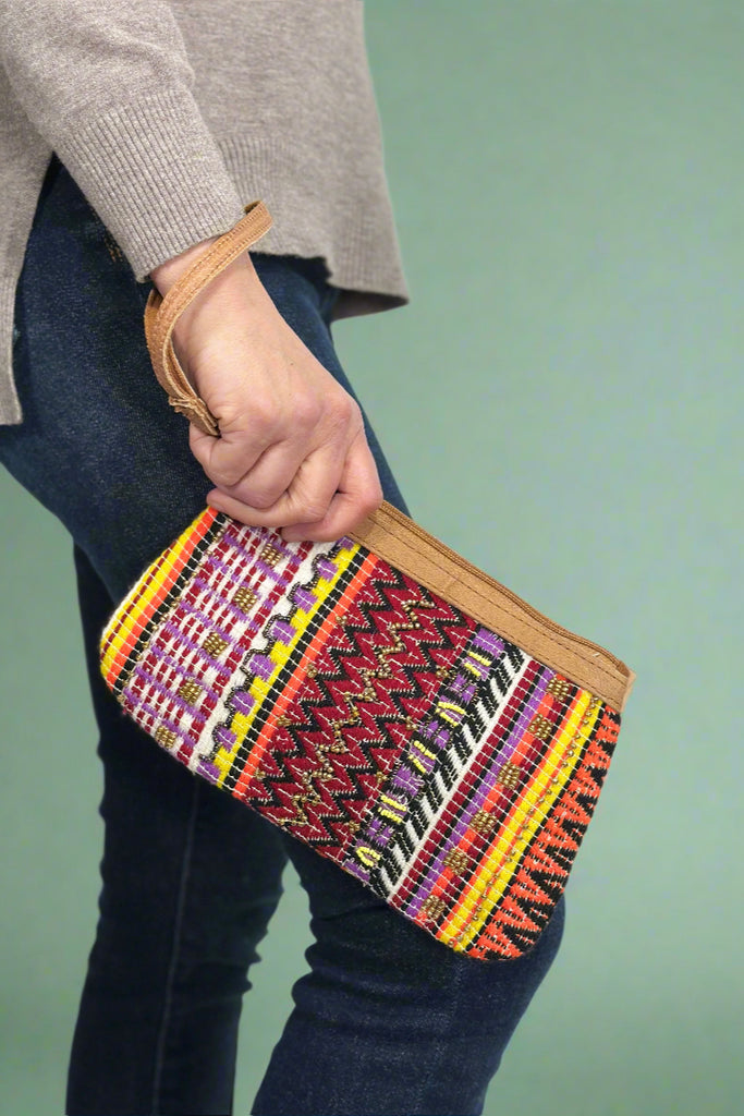 Model is holding a colorful beaded wristlet. 