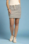 Model is wearing an ivory and black striped terry cloth above the knee skirt with pockets and an adjustable tie waist. 