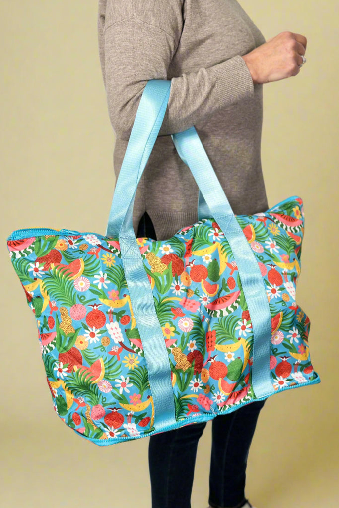 Model is holding a fruit printed foldable tote bag.