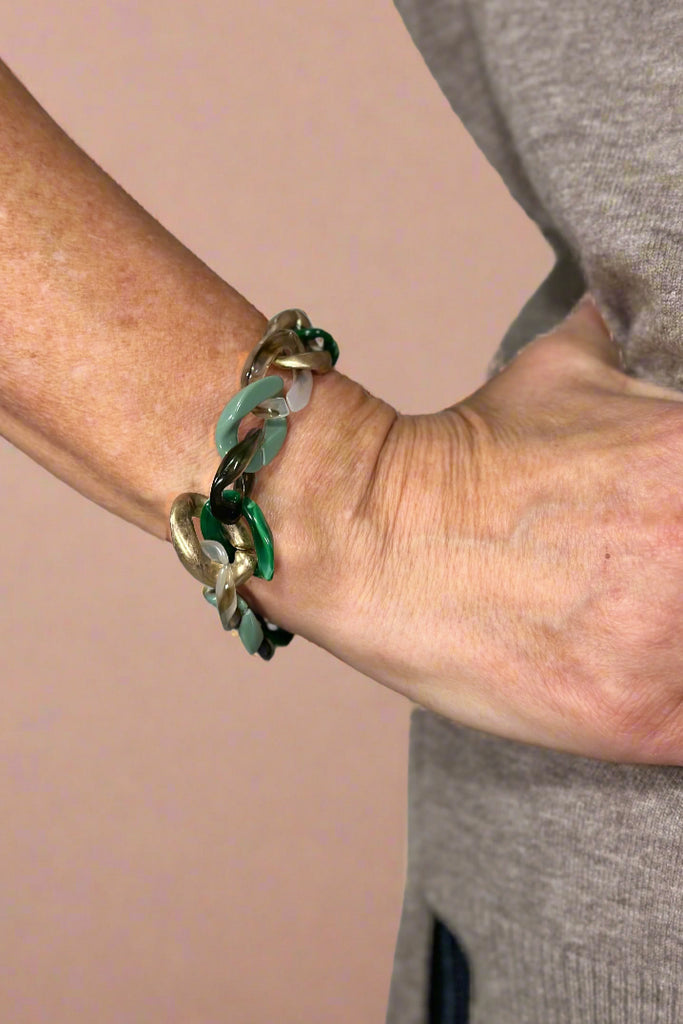 Model is wearing an acrylic chain link bracelet. 