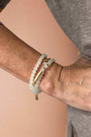 Model is wearing a white beaded wrap bracelet. 