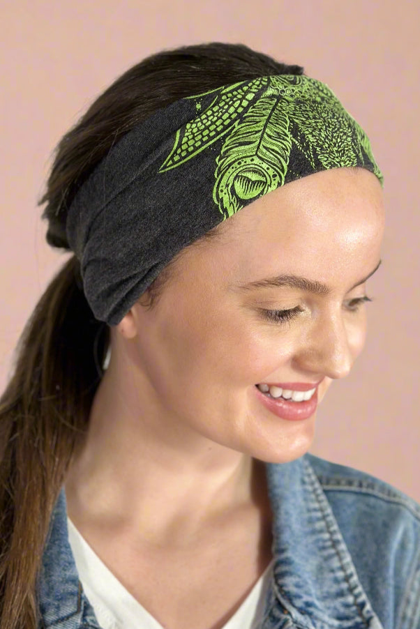 Model is wearing a heather grey headband with a green sacred canabis design printed on it. 