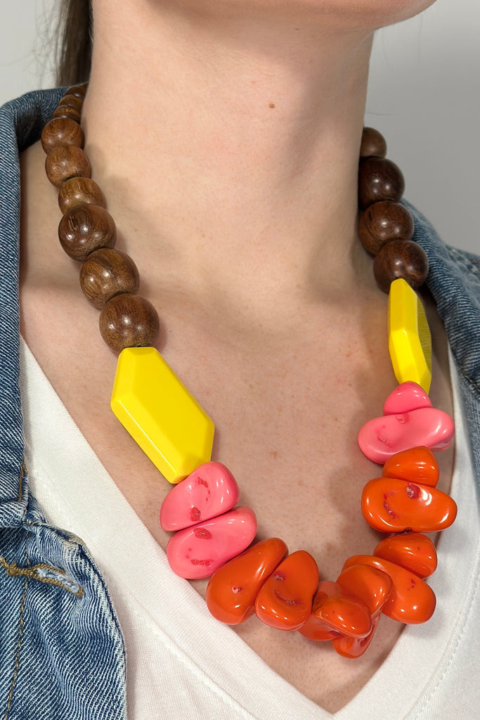 Model is wearing a chunky beaded statement necklace.