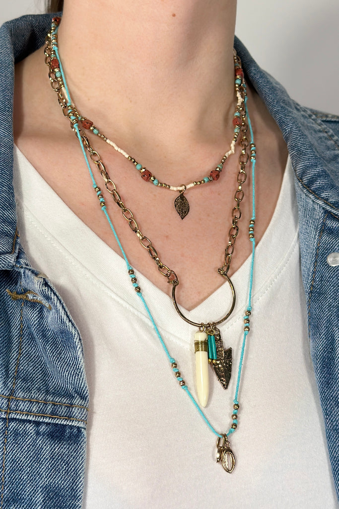 Model is wearing a boho inspired layered necklace.