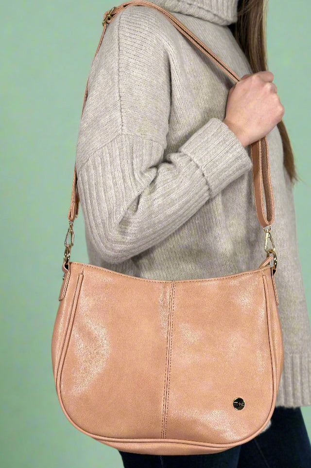 Women’s classic faux leather satchel purse in blush pink with removable adjustable faux leather strap for crossbody or shoulder wear and removable chain strap for shoulder wear.