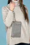 Small faux leather, 3 compartment bag in grey with zipper closure and removable wristlet and adjustable crossbody straps.