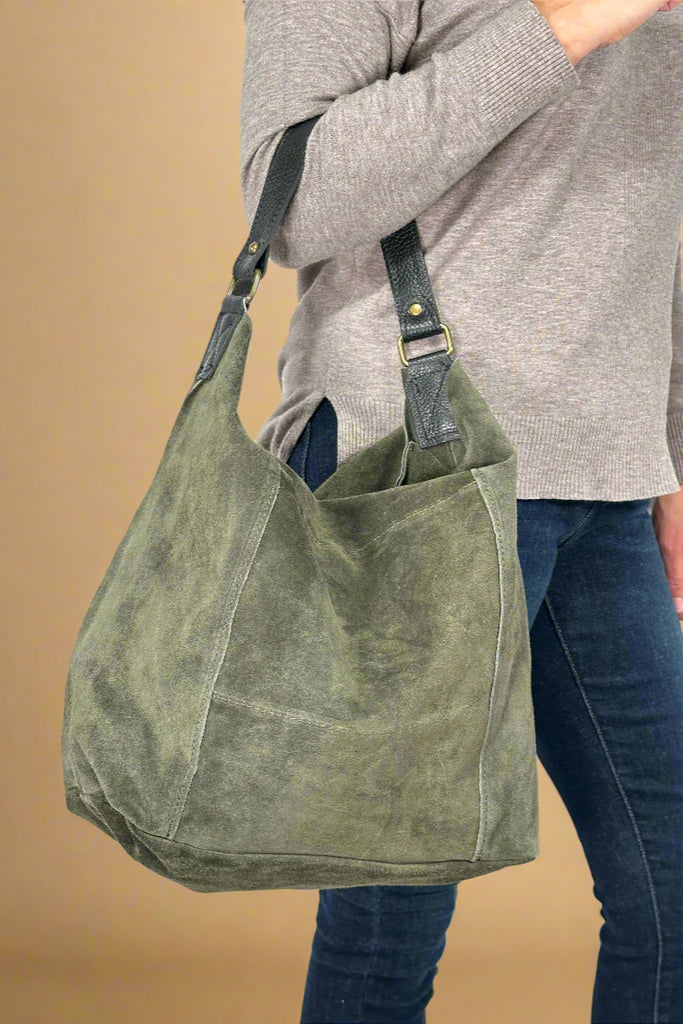 Women’s large Italian leather suede handbag in olive green with zipper closure and shoulder strap.