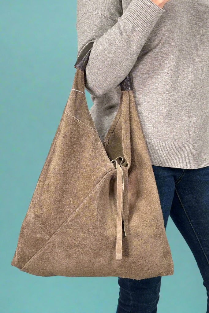 Women’s Italian leather suede shoulder bag in taupe with matching coin purse and tie closure.