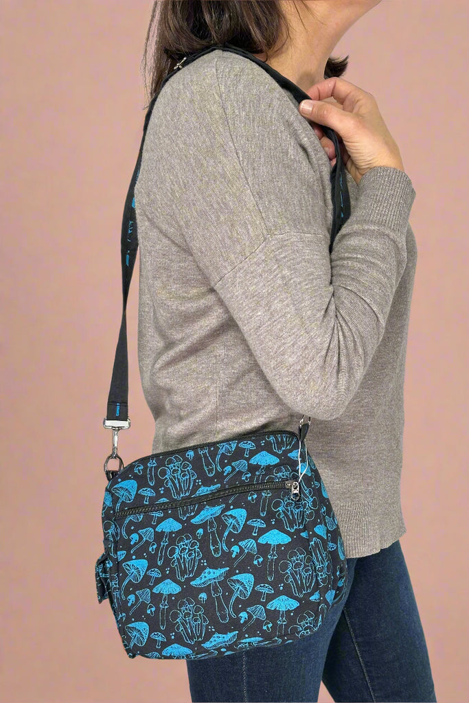 Model is wearing a mushroom printed crossbody bag. 