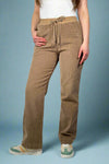 Model is wearing chocolate brown corduroy pants with an elastic tie waist.