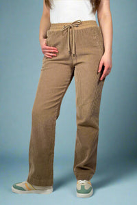 Model is wearing chocolate brown corduroy pants with an elastic tie waist.