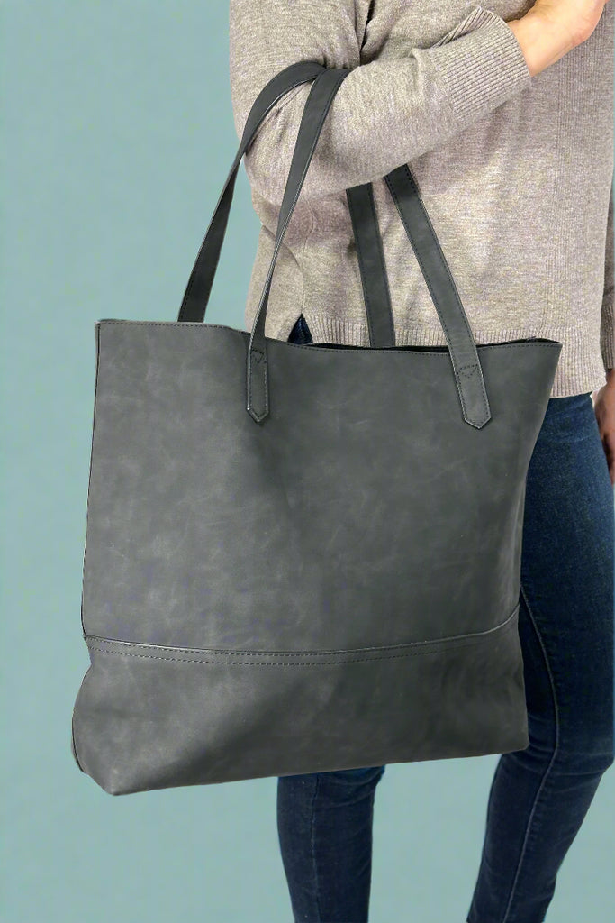 Women’s large tote bag in black faux suede with open top and RDIF protected card slots inside.