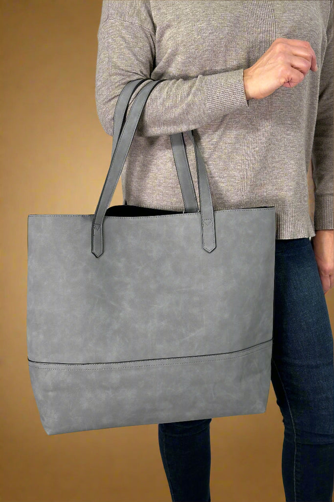 Women’s large tote bag in grey faux suede with open top and RDIF protected card slots inside.