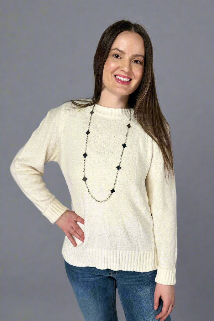 This soft, white color sweater is made from super soft fabric. It is a crewneck and features a unique shoulder detail.