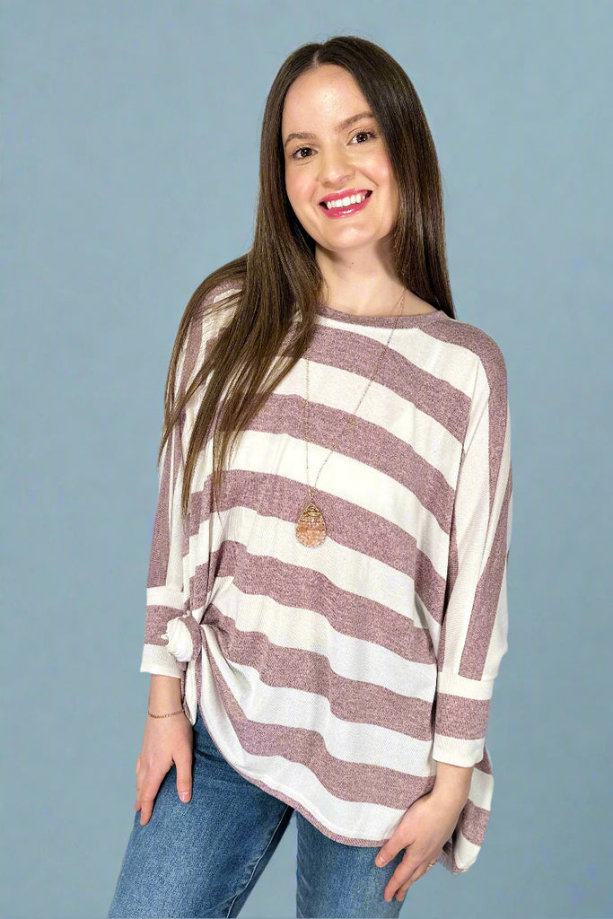 This oversized, batwing top has horizontal stripes in berry and white. It is lightweight and long in length.