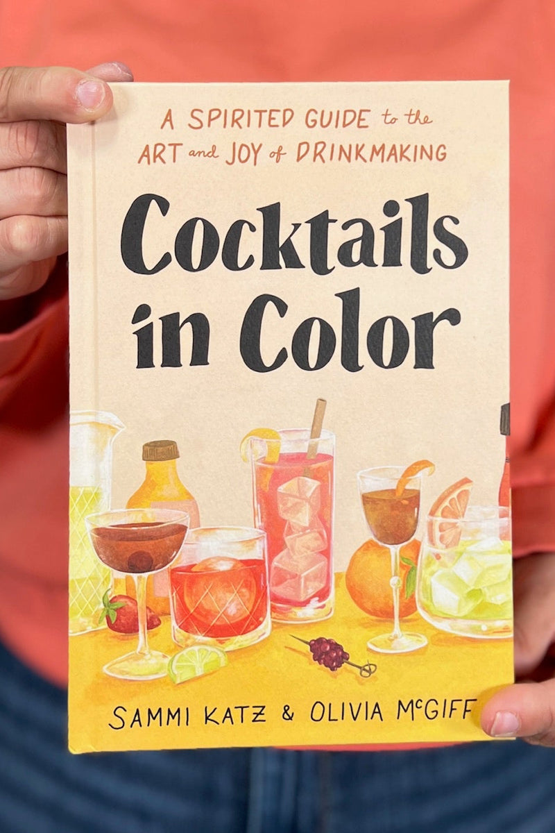 A small hardcover book titled “Cocktails in Color”.