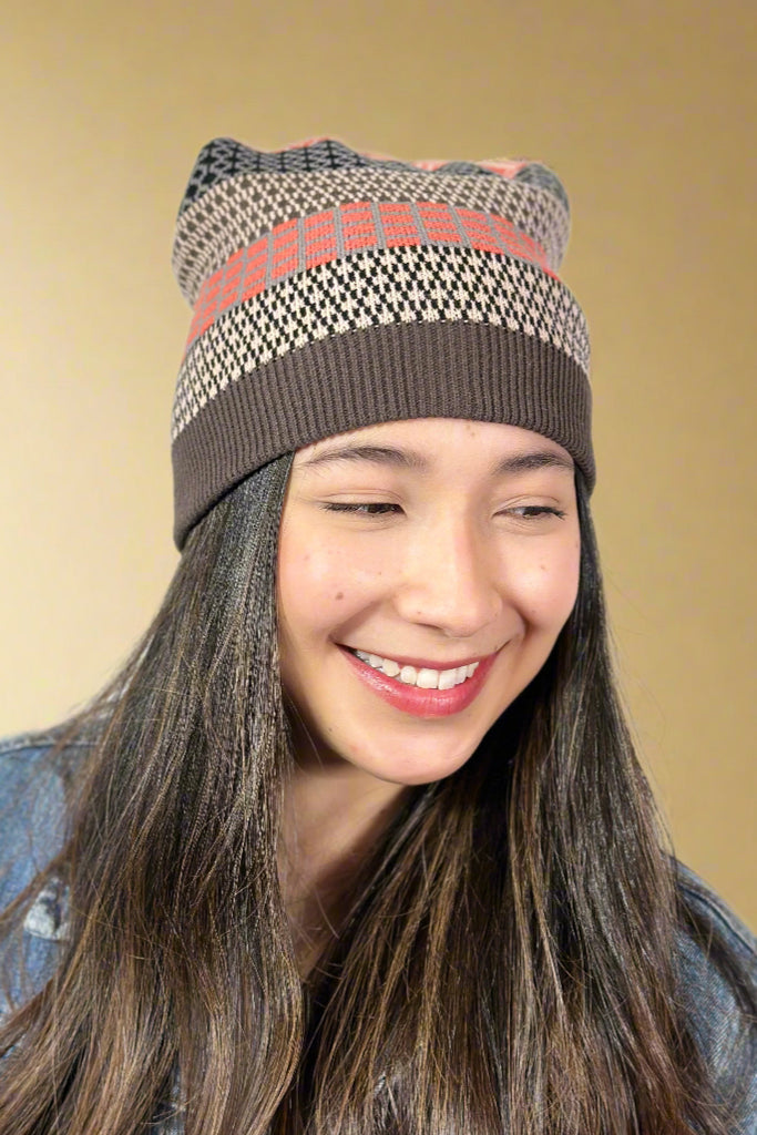 Model is wearing a geometric printed winter hat.