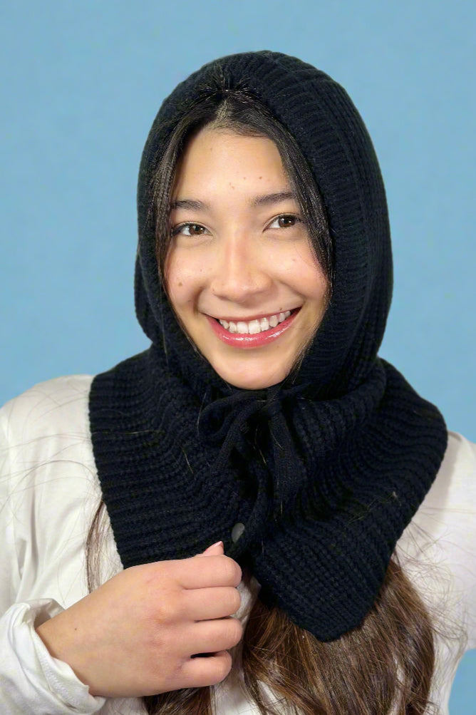 Model is wearing a black colored knit balaclava that ties and has snap buttons.