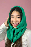 Model is wearing a kelly green colored knit balaclava that ties and has snap buttons.