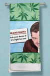 A green and blue kitchen towel that says “ Marijuana - Ask your doctor if it's right for you!”