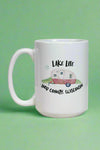 A white 10o mug with a graphic of a camper and says Lake Life Door County , Wisconsin.