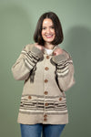 Woman wearing a patterned beige jacket on a gray background