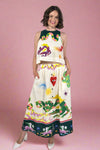Woman wearing a colorful dress with various designs on a white background