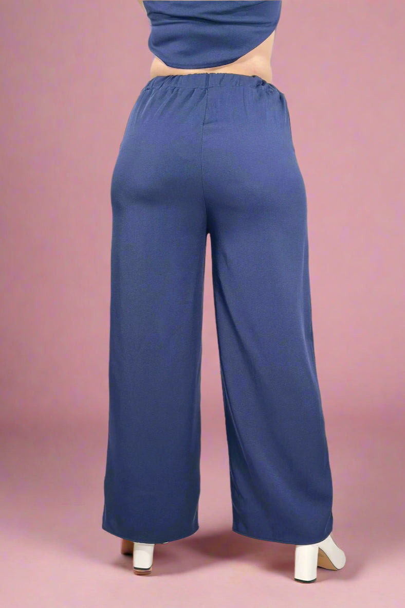 Blue wide-leg pants worn by a person on a plain background