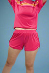 Person wearing a pink sports outfit with a white background