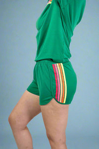 Green athletic outfit with colorful stripes on a plain background