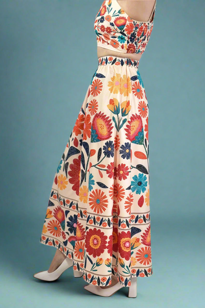 Colorful floral crop top and skirt set on a blue background