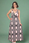 Woman wearing a pink and black patterned spaghetti strap maxi dress 
