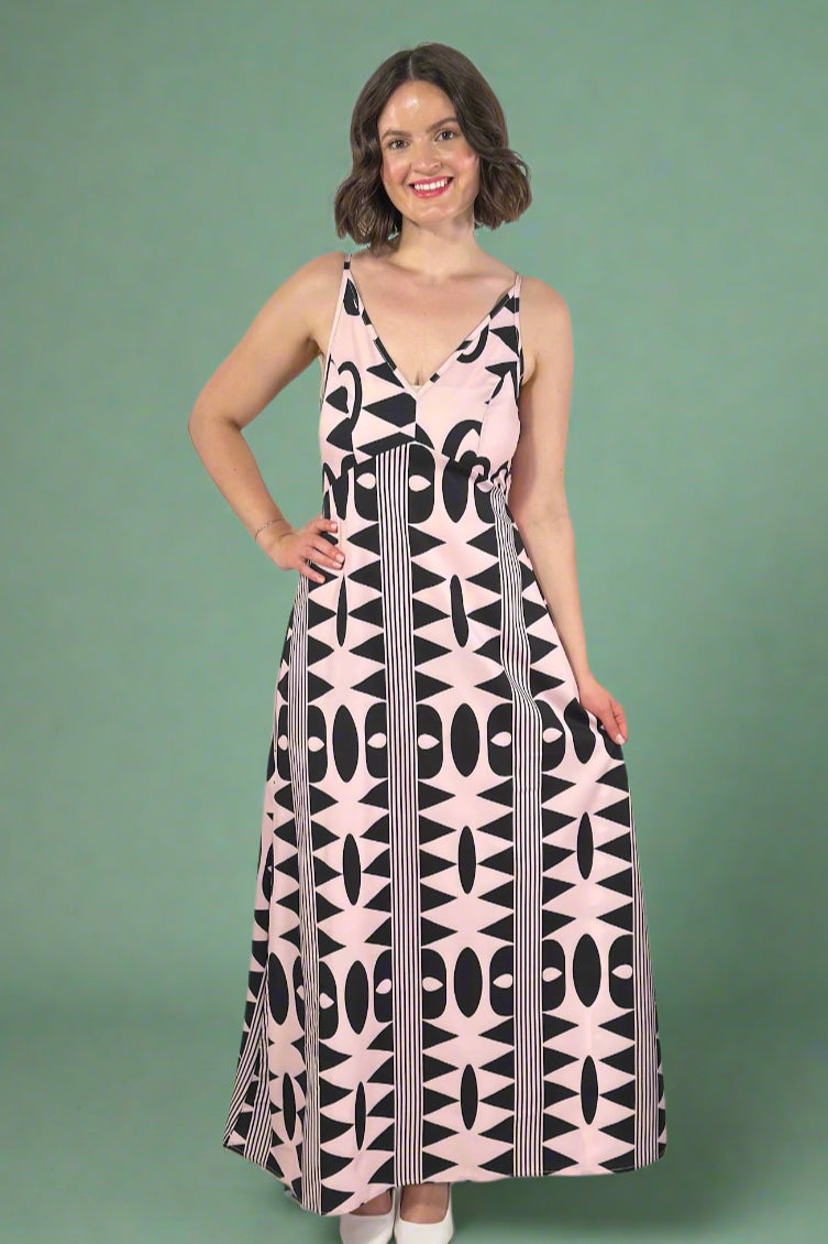 Woman wearing a pink and black patterned spaghetti strap maxi dress 