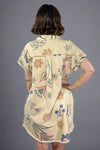Woman wearing a floral dress with a plain background