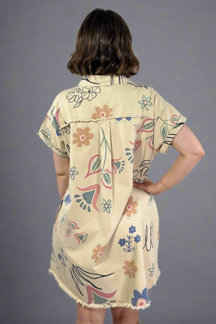 Woman wearing a floral dress with a plain background