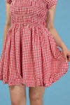 Red and white checkered dress on a plain background