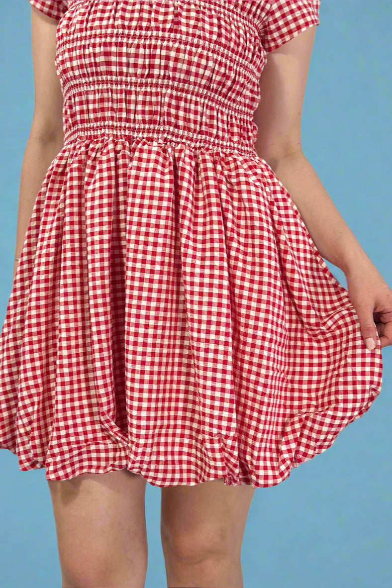 Red and white checkered dress on a plain background
