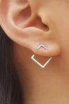 Ear jacket style earrings that together look like a small silver square. 