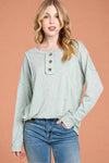 This sage long sleeve top has exposed hems and a 1/4 button neckline.