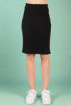 A women’s black rib knit knee length pencil skirt featuring a slit in the back, elastic waistband, and soft stretchy material all made in the USA.