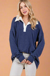 A womens oversized long sleeve top in navy blue featuring contrasting white collar, soft ribbed material, and drop shoulder fit.