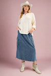 A women’s midi length, a-line, elastic waisted cargo pocket skirt in a soft faded medium wash denim.