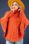 Women’s orange mock neck long sleeve sweater poncho featuring cable knit detail.