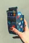 A navy space themed can cooler/wallet combo.